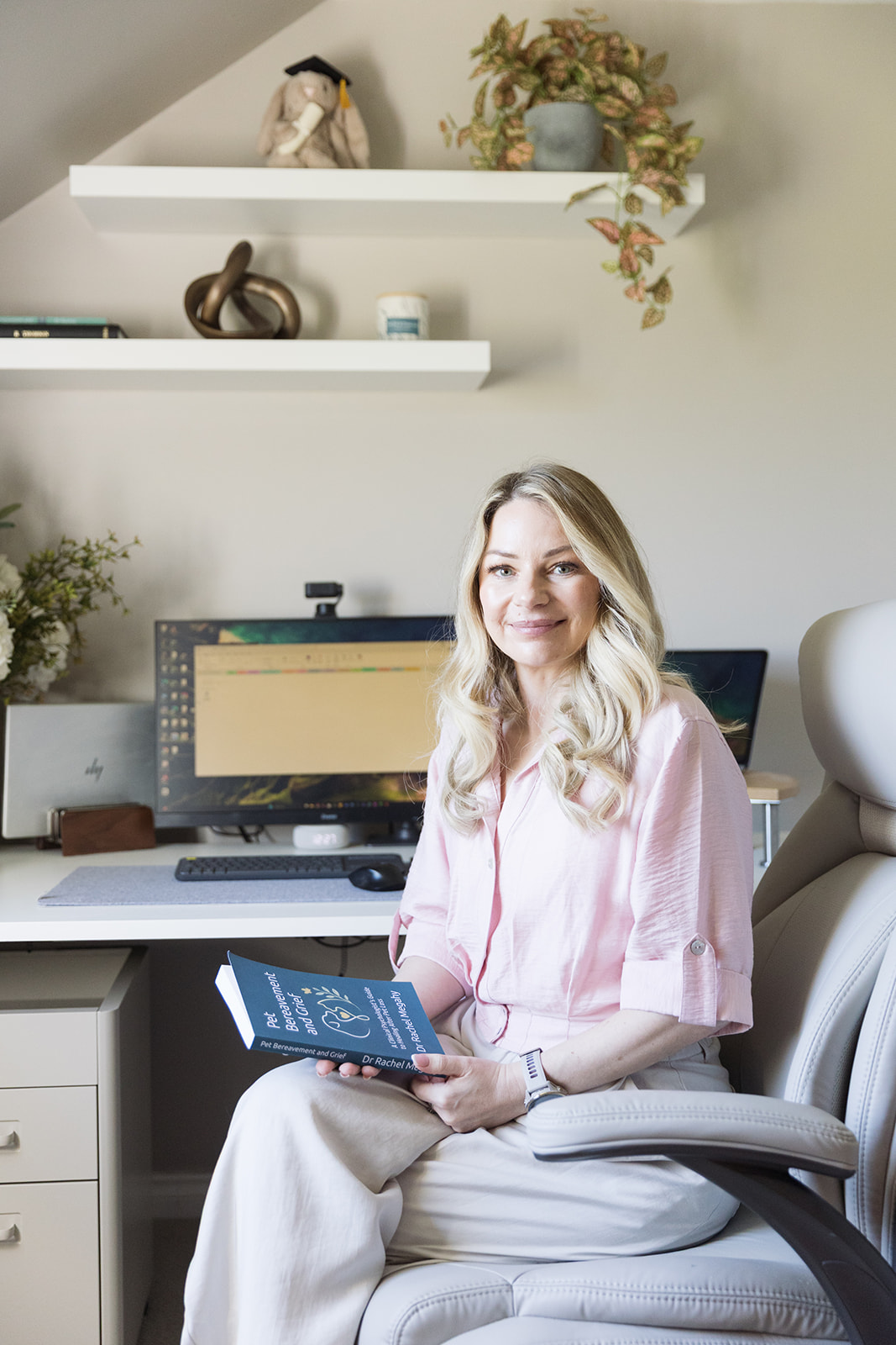Dr Rachel Megahy, Clinical Psychologist, holding her book at her home office in the Scottish Borders