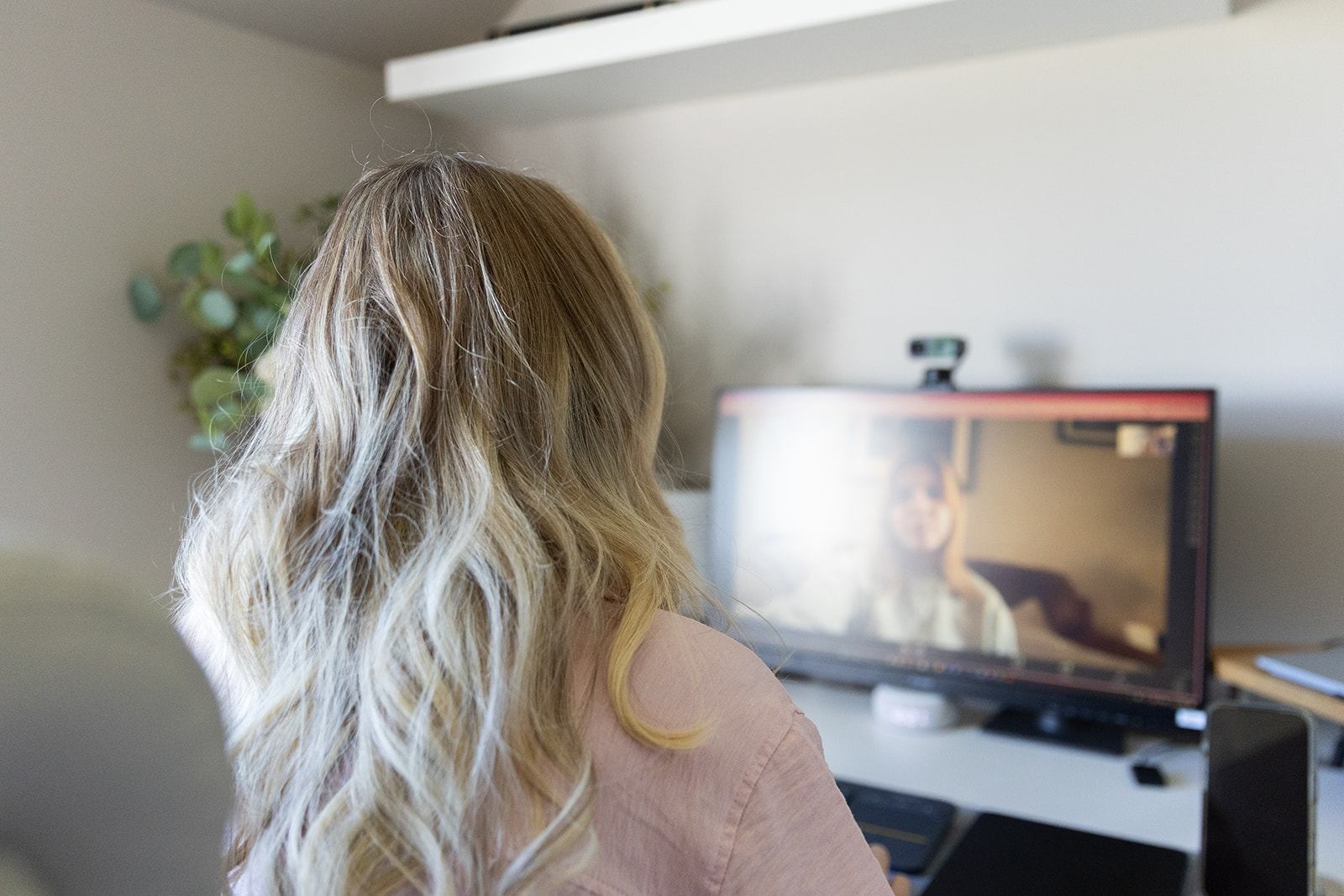 A laptop set up for an online therapy session in a quiet, comfortable room